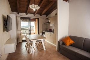 ein Wohnzimmer mit einem Tisch und einem Sofa in der Unterkunft Sobìa Pitticca in Chia