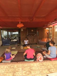 een groep mensen die op de vloer zitten in meditatie bij Domaine d'Escapa in Estipouy