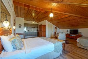 a bedroom with a large bed and a kitchen at My Marina Select Hotel in Datca