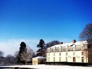 a large white building with snow on top of it at Domaine de Montchevreuil in Fresneaux-Montchevreuil +28 photos