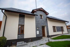 a house with a black and white at apartmány U Solišů in Klimkovice