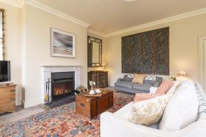 a living room with a couch and a fireplace at The Courtyard House in Dorchester