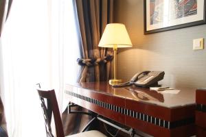 a desk with a lamp and a lamp post at Piraeus Theoxenia Hotel in Piraeus