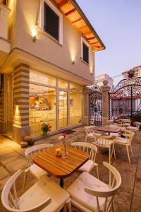 a patio with tables and chairs and a building at Villa Ester in Korçë