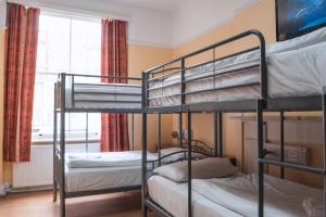 two bunk beds in a room with a window at Dolphin Inn - The Lodge in London