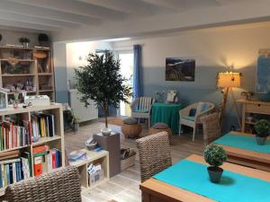 a living room with a table and a dining room at Mas Du Cadranier in Villeneuve