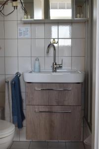 a bathroom with a sink and a toilet at Haus Neunaber in Norderney