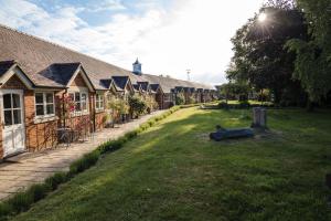 a row of houses in a yard next to a street at Cantley House Hotel - Wokingham in Wokingham