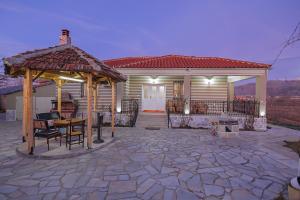 a house with a gazebo and a patio at Vila 1 in Korçë