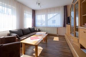 a living room with a couch and a table at Ferienhof Rüßmann in Lennestadt