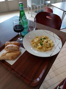 a plate of pasta and a glass of wine on a table at Campanile Saintes in Saintes