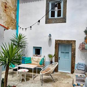 a patio with a couch and chairs and a table at Casa Pescador Peniche in Peniche