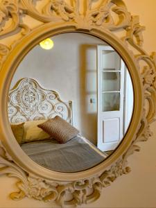 a bedroom with a bed in a mirror at Casa Pescador Peniche in Peniche