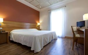 Postel nebo postele na pokoji v ubytování Hotel Bulevard