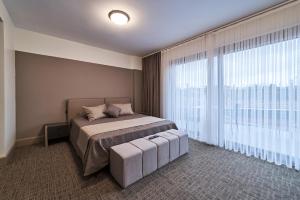 a bedroom with a bed and a large window at Selini Hotel İstanbul Airport in Istanbul