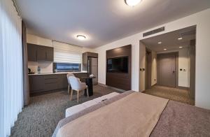 a hotel room with a bed and a kitchen at Selini Hotel İstanbul Airport in Istanbul
