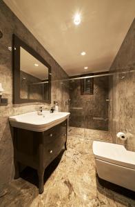 a bathroom with a sink and a tub and a mirror at Selini Hotel İstanbul Airport in Istanbul