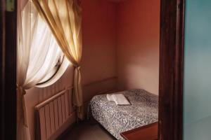 a small room with a bed and a window at Mini hotel Gavan Nadiezhdy in Zhukovsky