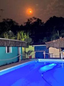 a night view of a swimming pool at a house at Chales Bora Bora - Boraceia in Boracéia