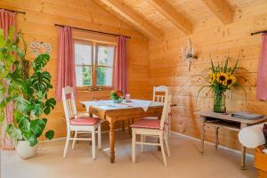 a wooden dining room with a table and chairs at Alchemilla in Bad Feilnbach