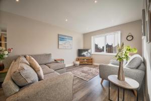 a living room with a couch and a table at Host & Stay - Sunflower Cottage in Seahouses +21 photos