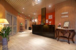 a lobby with a desk in the middle of a room at Hotel Sully in Nogent-le-Rotrou