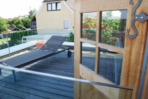 a treadmill on a deck next to a glass door at Alte Schmiede in Bad Griesbach