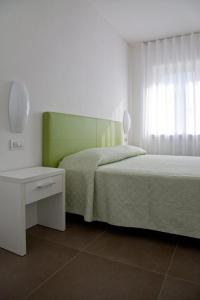 1 dormitorio con 2 camas, mesa y espejo en Casa Rosa dei Venti, en Nago-Torbole