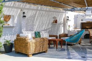 a patio with wicker chairs and a table at Christou Estate & Villas in Pyrgos
