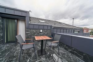a table and chairs on the balcony of a house at Selini Hotel İstanbul Airport in Istanbul