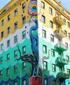 a statue of a peacock in front of a building at Roma House Piramide in Rome