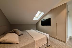 a bedroom with a bed and a skylight at Selini Hotel İstanbul Airport in Istanbul