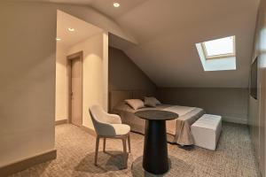 a bedroom with a bed and a table and a chair at Selini Hotel İstanbul Airport in Istanbul