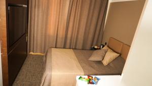 a small bedroom with a bed in a room at Selini Hotel İstanbul Airport in Istanbul