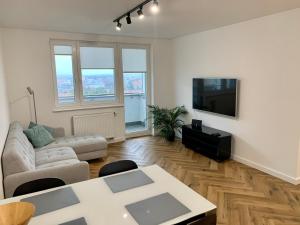 a living room with a couch and a tv at Apartamenty Asapartment Stockholm in Olsztyn