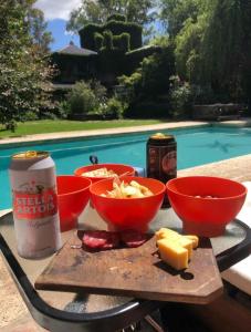 a table with three bowls of cheese and a can of soda at La Ignacia Bed and Breakfast in Pilar