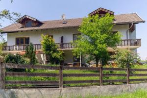 a house with a fence in front of it at Ferienwohnung Landurlaub in Bad Feilnbach