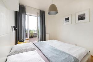 a bedroom with a bed and a large window at Mountain Apartment Vrchlabi in Vrchlabí