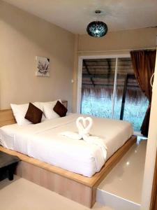 Krevet ili kreveti u jedinici u objektu Suwi Coco Ville Resort
