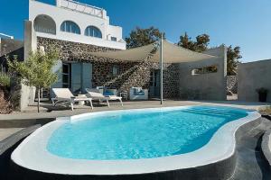 a swimming pool in front of a house at Christou Estate & Villas in Pyrgos