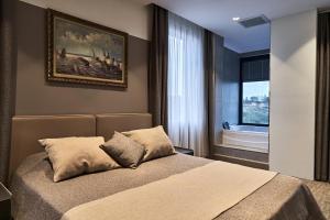 a bedroom with a bed and a painting on the wall at Selini Hotel İstanbul Airport in Istanbul