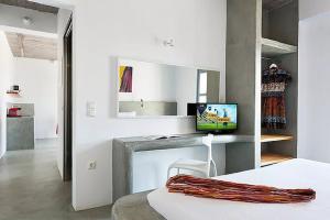 a white room with a bed and a computer on a counter at Christou Estate & Villas in Pyrgos +61 photos