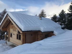 a cabin with snow on top of a pile of snow at Bogi Hütte -Falkert in Patergassen