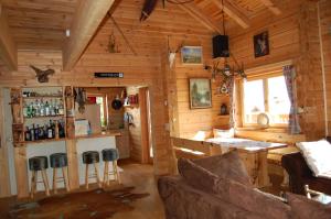 a living room of a log cabin with a bar at Bogi Hütte -Falkert in Patergassen