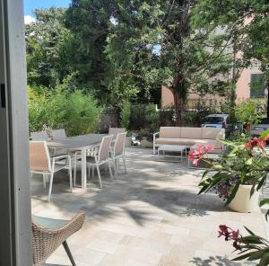 a patio with a table and chairs and a couch at SantAgata bed&breakfast in Como