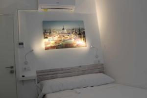 a bedroom with a picture on the wall above a bed at Hostal royal begoña in Madrid