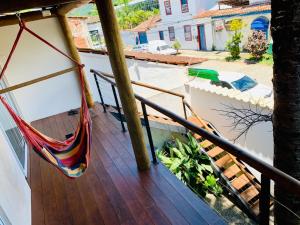 a hammock on the balcony of a house at Pontal Flats in Paraty