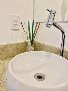 a white sink with a faucet on a counter at Pontal Flats in Paraty