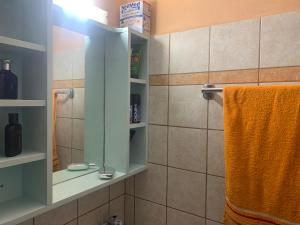 a bathroom with a shower with a mirror and towels at Patmos Villas in Grikos