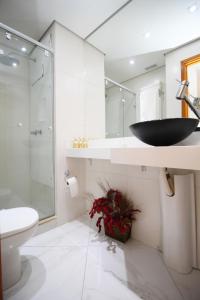 a bathroom with a black sink and a shower at Alameda Lorena Apartment in São Paulo